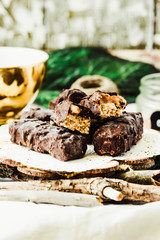 Homemade raw chocolate candy snickers bars. Selective focus.