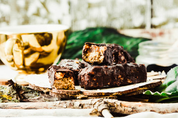 Homemade raw chocolate candy snickers bars. Vegan dessert.