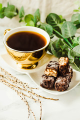 Homemade raw chocolate candy. Snickers bars with cup of coffee.