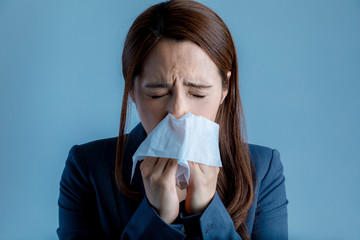 young woman blowing her nose. allergic rhinitis. hay fever.