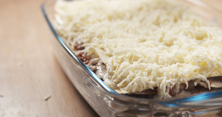 preparing traditional italian lasagna adding bechamel sauce, 4k photo