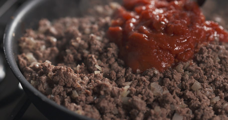 roasting minced beef with tomato paste in a pan, 4k photo