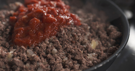 roasting minced beef with tomato paste in a pan, 4k photo