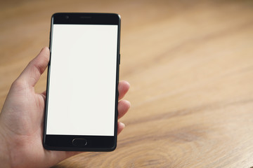 closeup shot of female teen hands with smartphone at the table, shallow focus