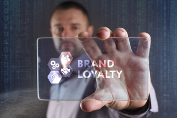 Business, Technology, Internet and network concept. Young businessman working on a virtual screen of the future and sees the inscription: Brand loyalty