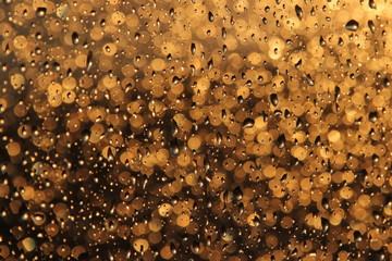 Raindrops on the window on sunset background
