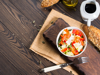 Colorful vegetable salad bowl for lunch on wooden rustic background