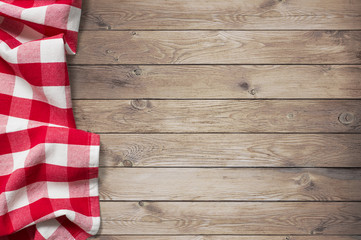 red picnic tablecloth on wood table background