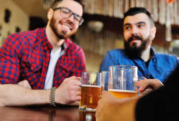 Company friends drink beer and smile