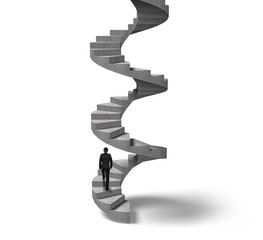 Businessman climbing concrete spiral staircase