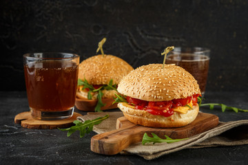 Homemade burger with arugula, tomato and cheese