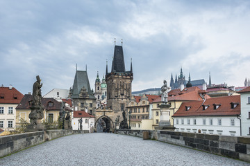 Fototapeta na wymiar Charles bridge (Karluv Most), Lesser Town Bridge Tower and the tower of the Judith Bridge with St. Vitus Cathedral on the background, Prague (UNESCO), Czech Republic