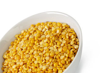 Dry yellow split peas isolated on white.