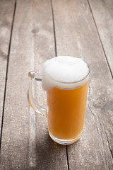 glass beer on wood background