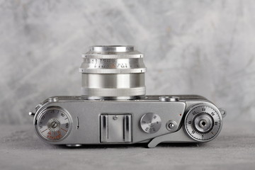 The old rangefinder camera on gray cement background.