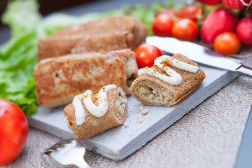 Pancakes with meat, fork and knife 
