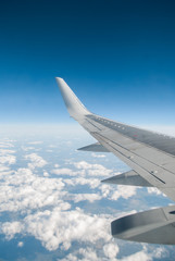 The wing of the plane on blue sky,