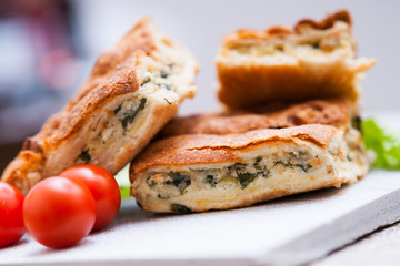 pie with meat and fresh vegetables on plate