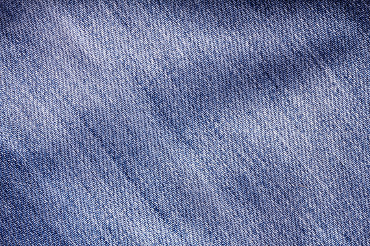 Close up the denim  blue jeans surface with wave texture background