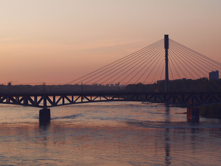 Vistula river and bridge at sunset in Warsaw, Poland. 