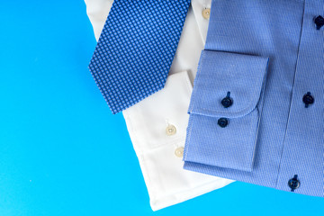 Stack of blue and white shirt closeup on a light background.