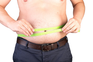 View of a the belly of a overweighted male scaling his waist with a measuring tape - isolated on white background