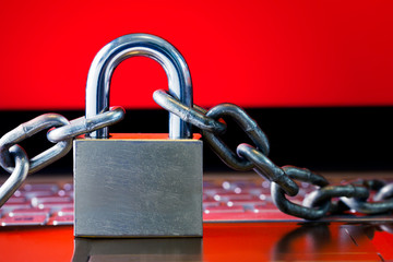 Ransomware,Malware,Encrypt and Hacking Conceptual with Padlock.The Old padlock and Chains On Laptop with Red Screen. Ransomware stops and block access to a Computer and Data