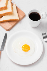 Top view of traditional healthy easy quick breakfast meal made of fried eggs served on a plate.