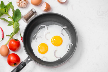 Fried eggs in a frying pan with cherry tomatoes and bread for breakfast