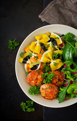 Farfalle pasta durum wheat with baked meatballs of chicken fillet  in tomato sauce and salad in  bowl. Top view. Flat lay