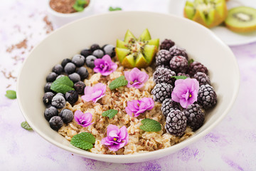 Tasty and healthy oatmeal porridge with fruit, berry and flax seeds. Healthy breakfast. Fitness food. Proper nutrition.