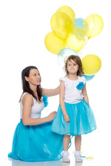 Mom and daughter with colorful balloons.