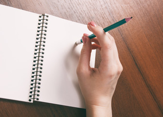 woman hands holding pencil down up rubber eraser. Top View with Copy Space