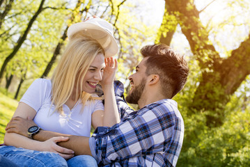 Flirting couple having fun in park on beautiful sunny day