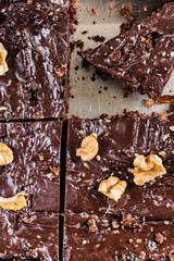 Raw vegan handmade brownie with walnuts in baking tray. Vegetarian concept of healthy food. Top view