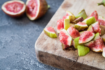 Chopped raw figs on wooden board