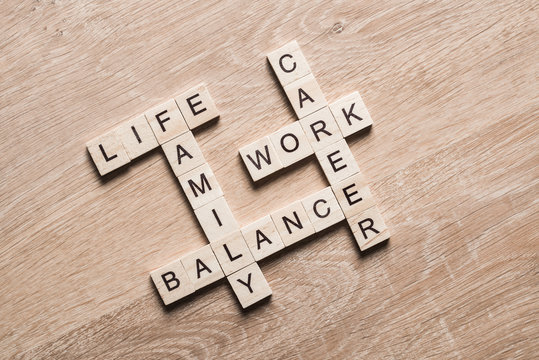 Words work life balance and family on table collected with wooden cubes