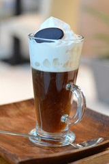 Viennese coffee with whipped cream on glass cup.