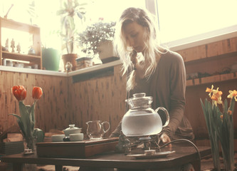 young beautiful blonde woman making tea ceremony