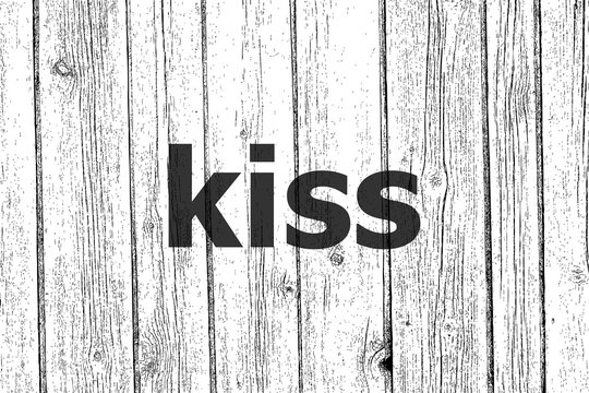 Text Kiss. Love concept . Wooden texture background. Black and white