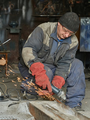 Grinding metal rail by the angle-grinding machine.