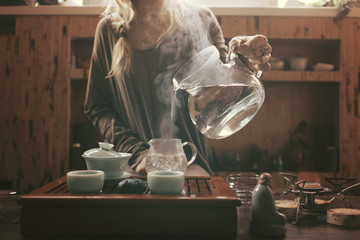 young beautiful blonde woman making tea ceremony