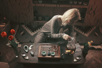 young beautiful blonde woman making tea ceremony