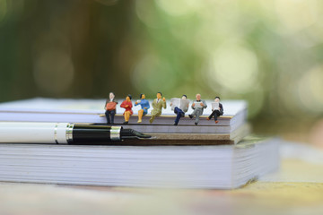 Businessman sitting on the book.