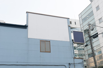 Large blank billboard on a street wall, banners with room to add your own text