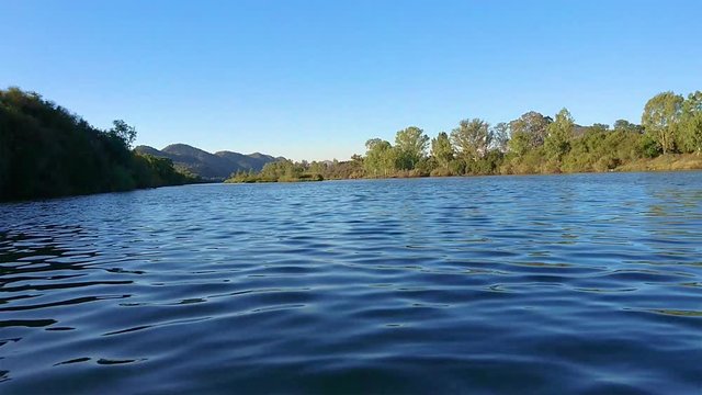 Slow moving water. View from canoe on Vaal River in South Africa. Border North West Provice and Free state