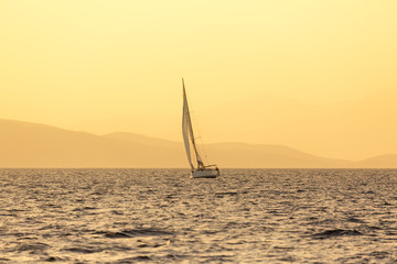 Fototapeta na wymiar Sailboat in Greece at sunset light