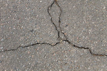 Texture with cracks on asphalt background