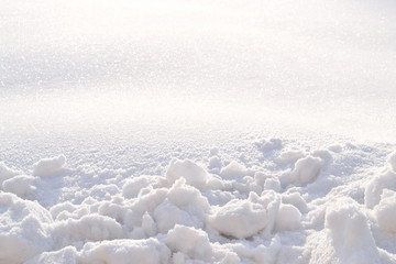 Friable thorny snow. Texture, background.
Pieces of icy snow and a flat snowy surface in the light of the morning sun.