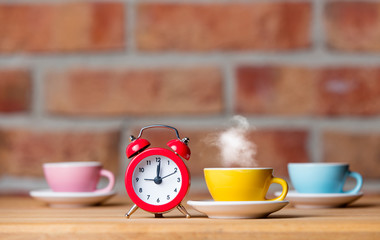 cups of coffee and alarm clock
